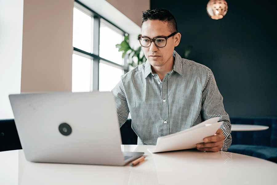 Man working on laptop in an open office space