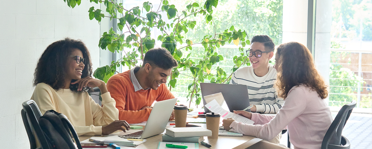 Group of professionals working together sitting at a table