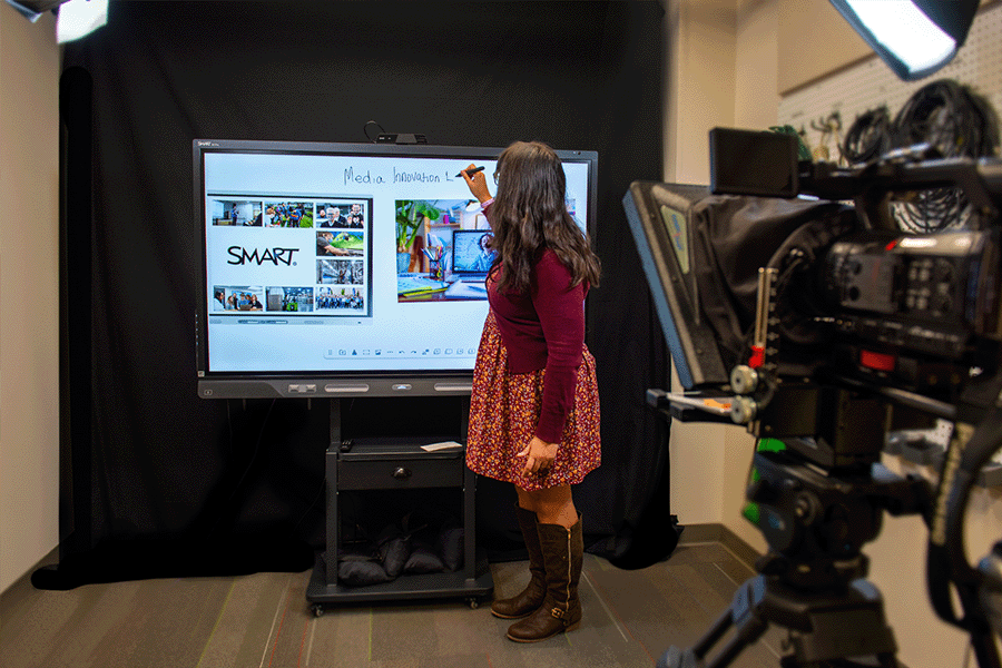 Instructor writing on a SMART board