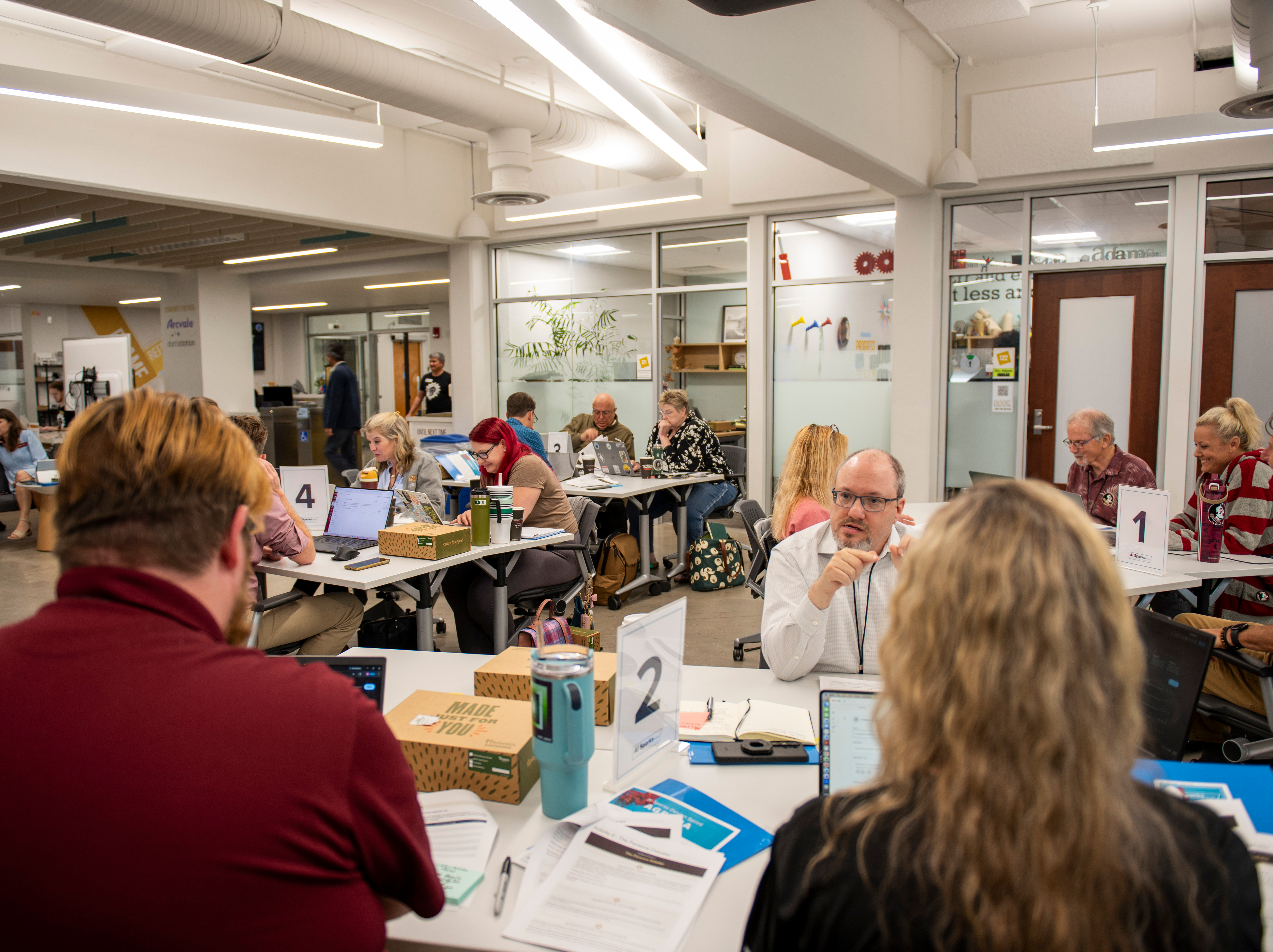 Faculty meet in small groups at the Innovation Hub