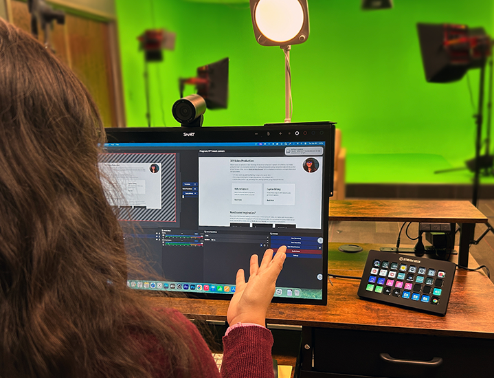Instructor using a computer monitor to demonstrate course content