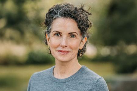 Image of Amber Ward in front of a green foliage background