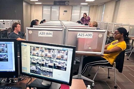 Photo of students being monitored while taking exams in the Testing Center
