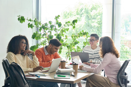 Group of professionals working together sitting at a table