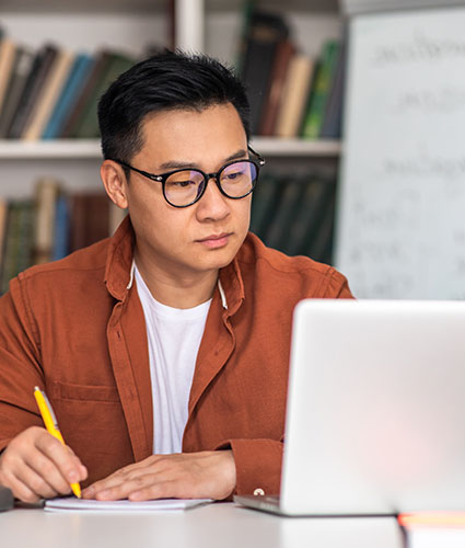 Woman working at a computer with headphones in