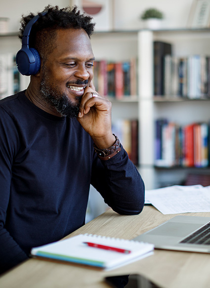 Image of person at computer with overlaying graphics showing they are working on documents