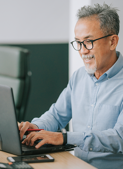 Man sitting at a computer working and typing